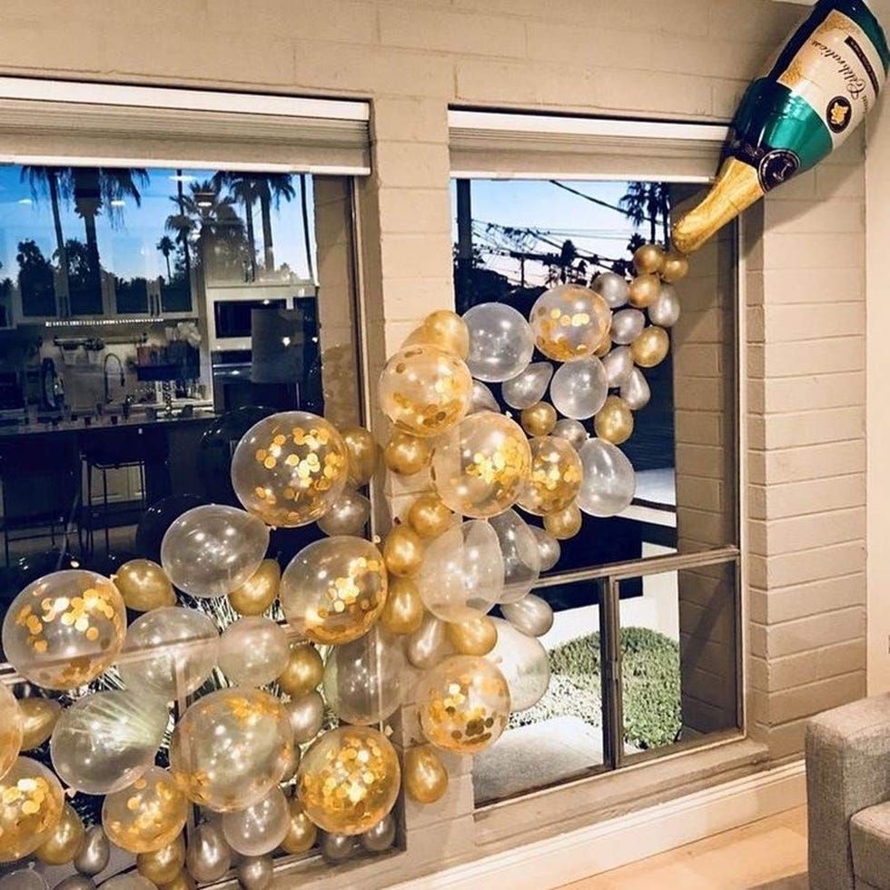 Flowing Gold, Silver, and Clear Balloon Garland Across a Window — New Years Eve Balloon Garland