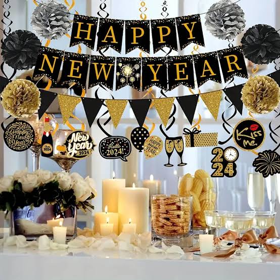 Tabletop Decorations with Black and Gold Banners and Pom-Poms — New Years Eve Party 2027