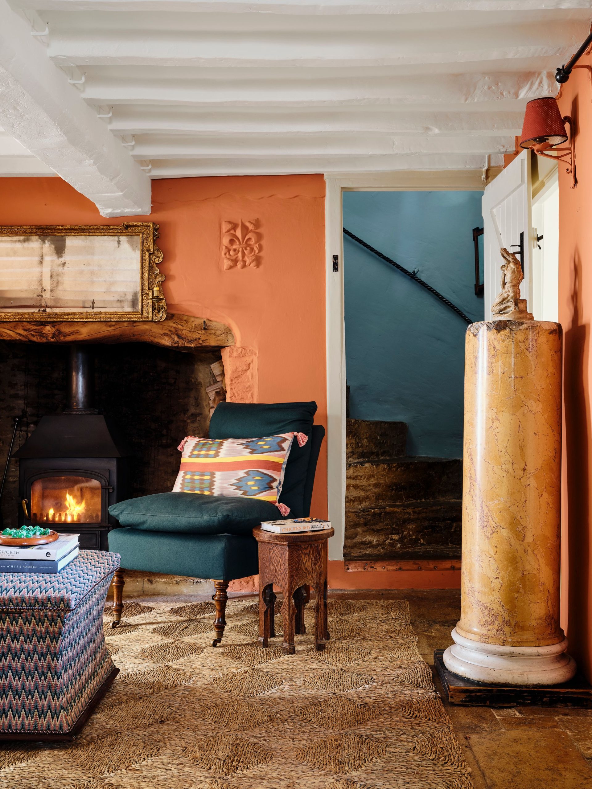 Eclectic Living Room with Wood-Burning Stove and Orange Walls — Winter Home Decor