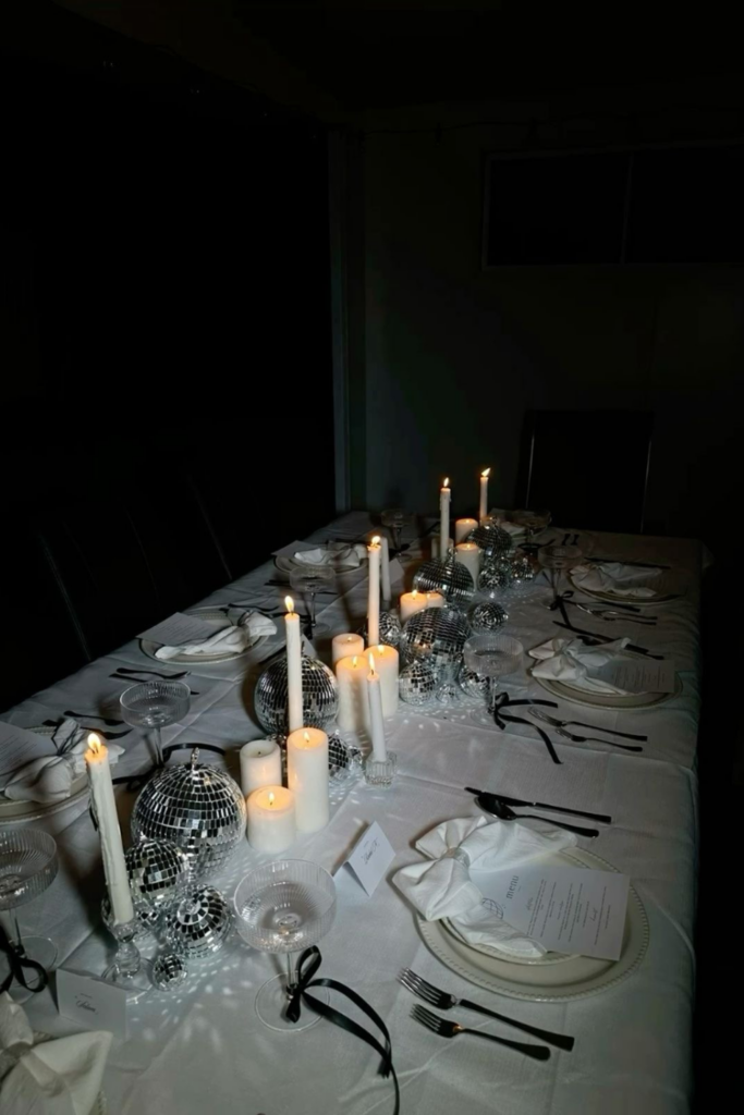 Glamorous Dining Table with Disco Ball Centerpieces and Candles — New Years Eve Party 2027