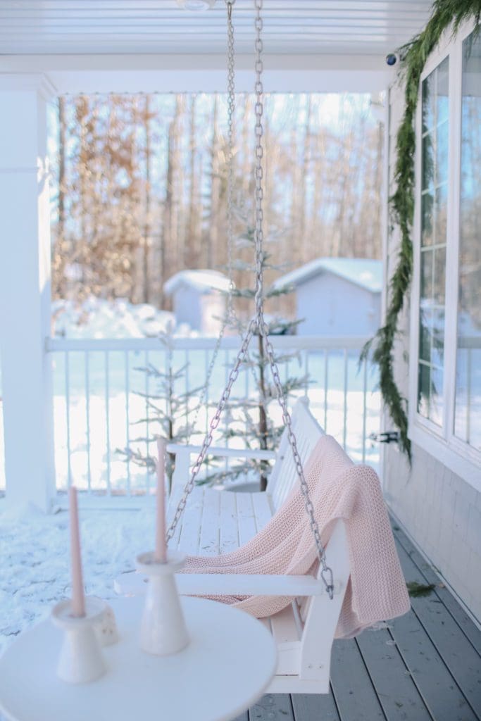 Cozy Porch Swing with Soft Pink Blanket Cozy Porch Swing with Soft Pink Blanket — Winter Porch Decor