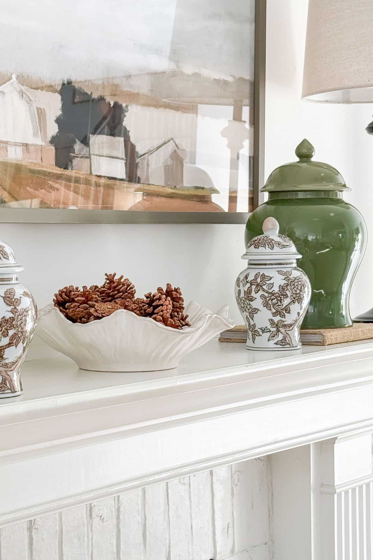 Simple Cozy Mantel with Greenery, Pinecones, and Jars — Winter Mantel Decor