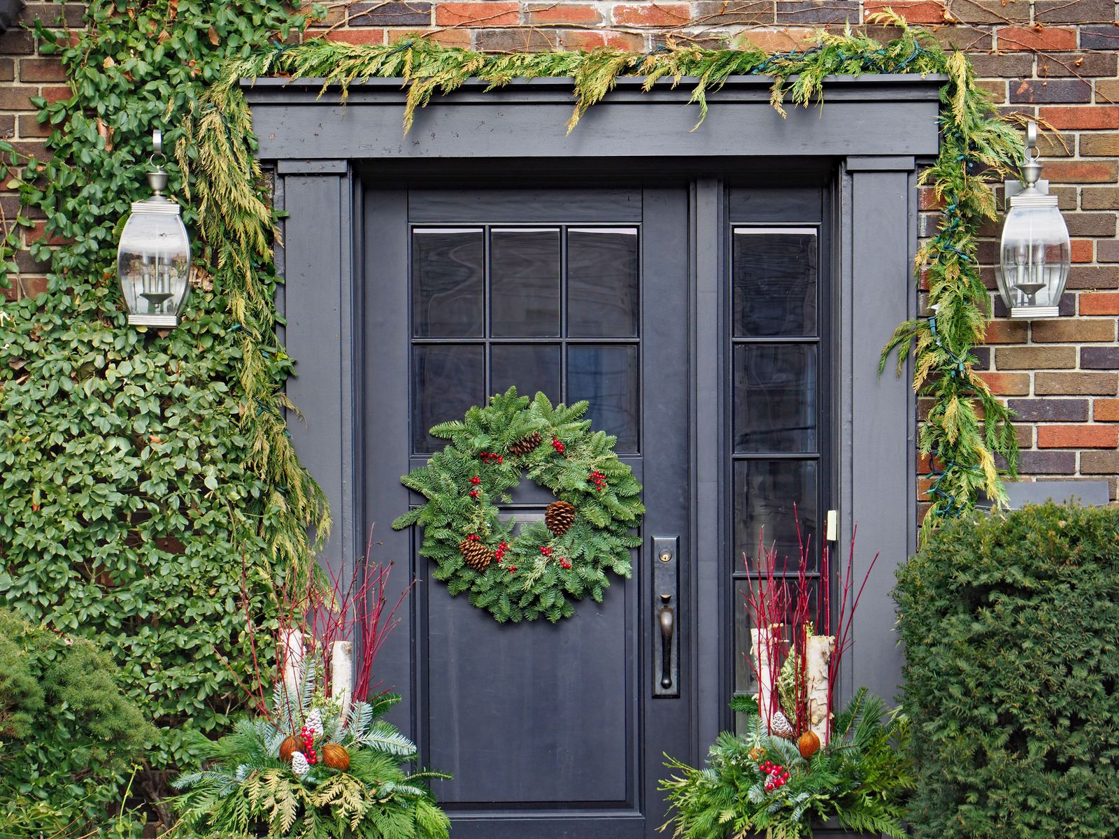 Traditional Entrance with Cascading Garland and Red Accents — Winter Front Door Decor