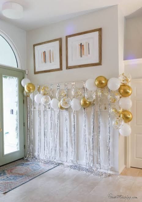Modern Gold and White Balloon Garland with Silver Fringe Backdrop in Entryway — New Years Eve Balloon Garland