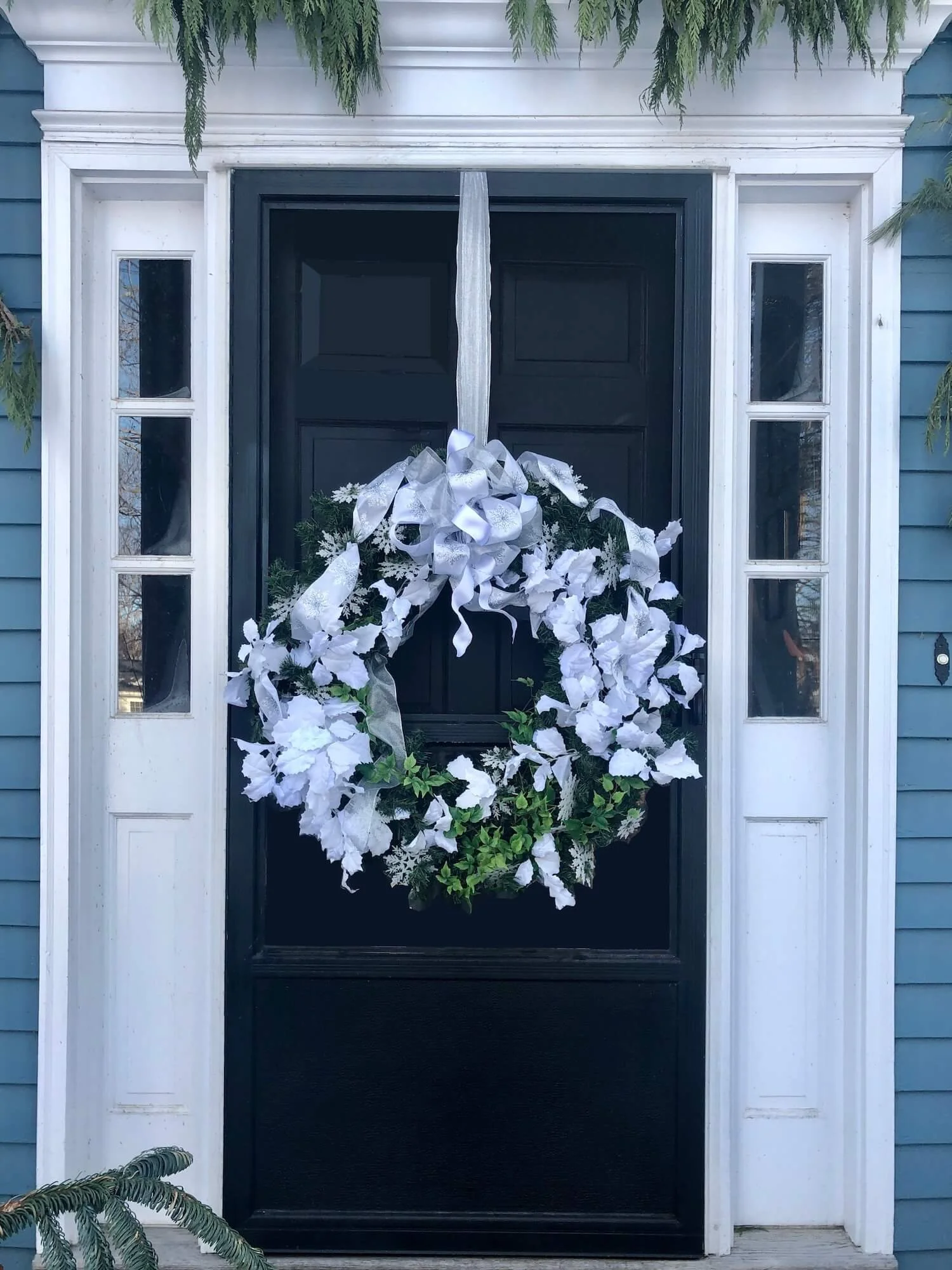 Striking Black Door with Voluminous White Floral Wreath — Winter Front Door Decor
