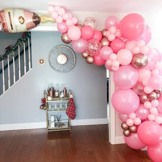 Pink and Rose Gold Balloon Garland Cascading Down Staircase — New Years Eve Balloon Garland