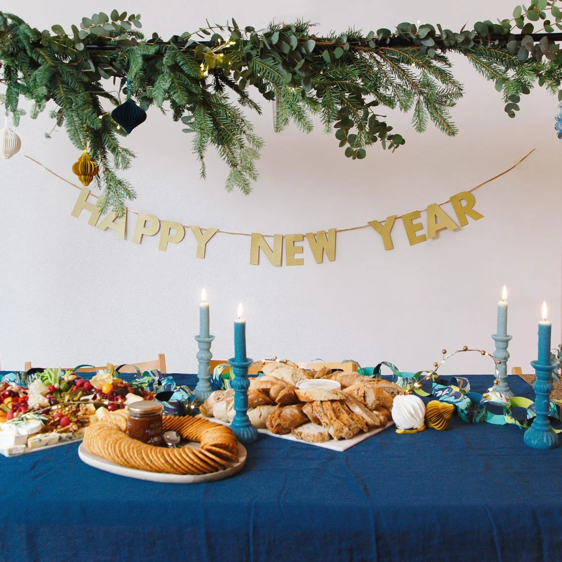 Set a Festive Dining Table with a 'Happy New Year' Banner and Greenery — New Years Eve Party 2027