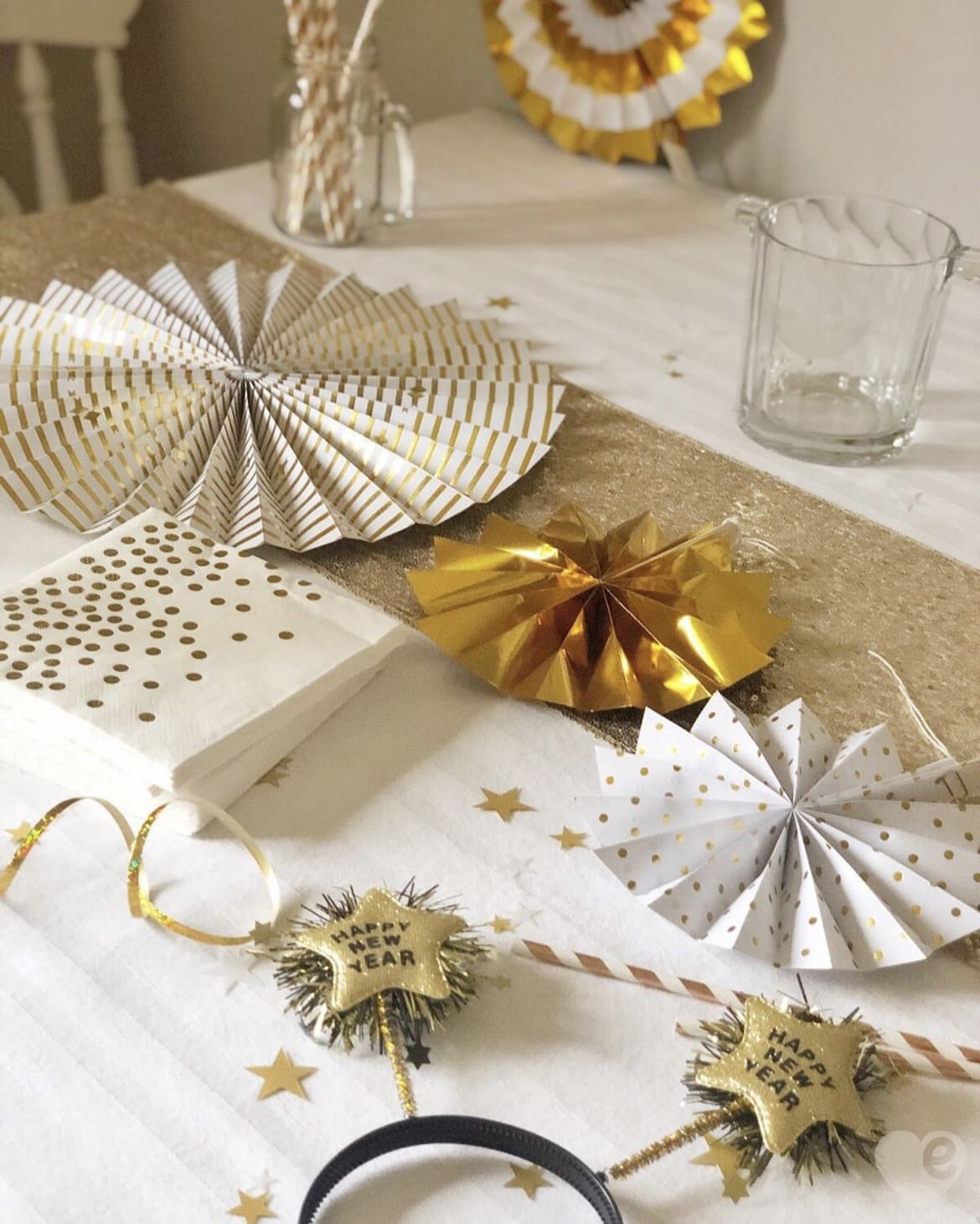 Gold and White Paper Fans and 'Happy New Year' Headbands for a Festive Flat Lay — Gold New Years Eve Decor