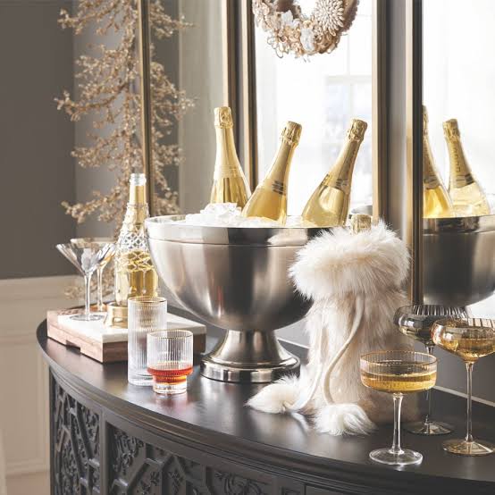 Chilled Gold Champagne Bottles in a Silver Ice Bucket for a Glam Bar — Gold New Years Eve Decor