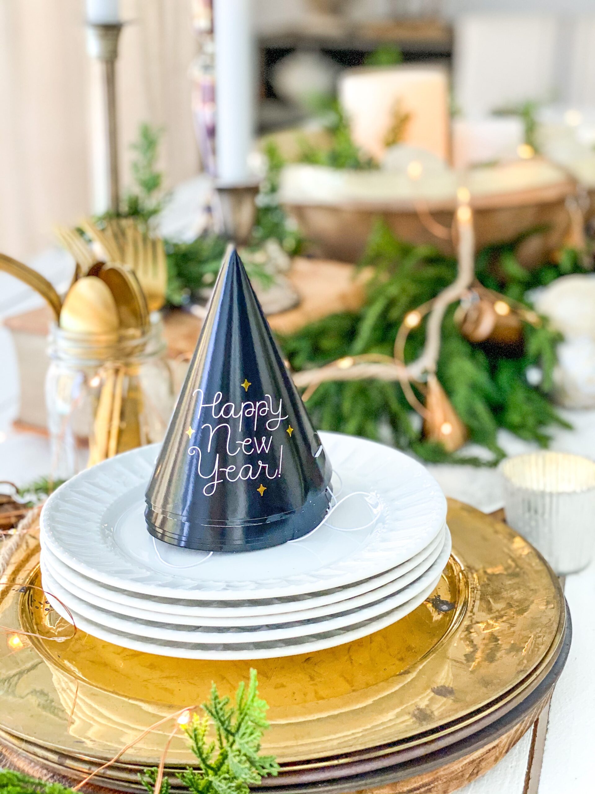 Playful 'Happy New Year' Hat on a Gold Charger Plate Setting — Gold New Years Eve Decor
