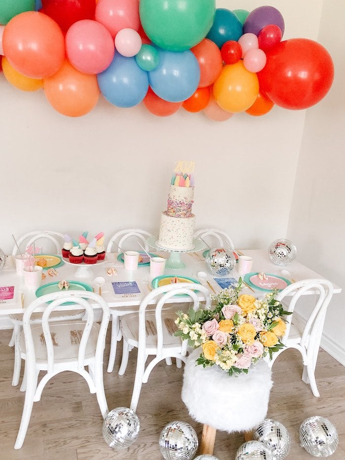Playful Party Table with Colorful Balloon Garland and Disco Balls — New Years Eve Party Decor