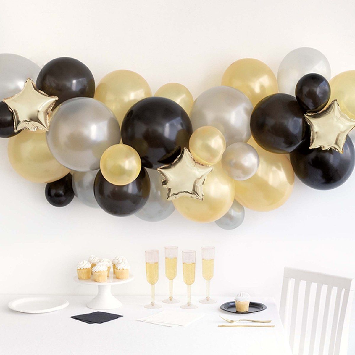 Black, Gold, and Silver Balloon Garland Over a Festive Table — New Years Eve Balloon Garland
