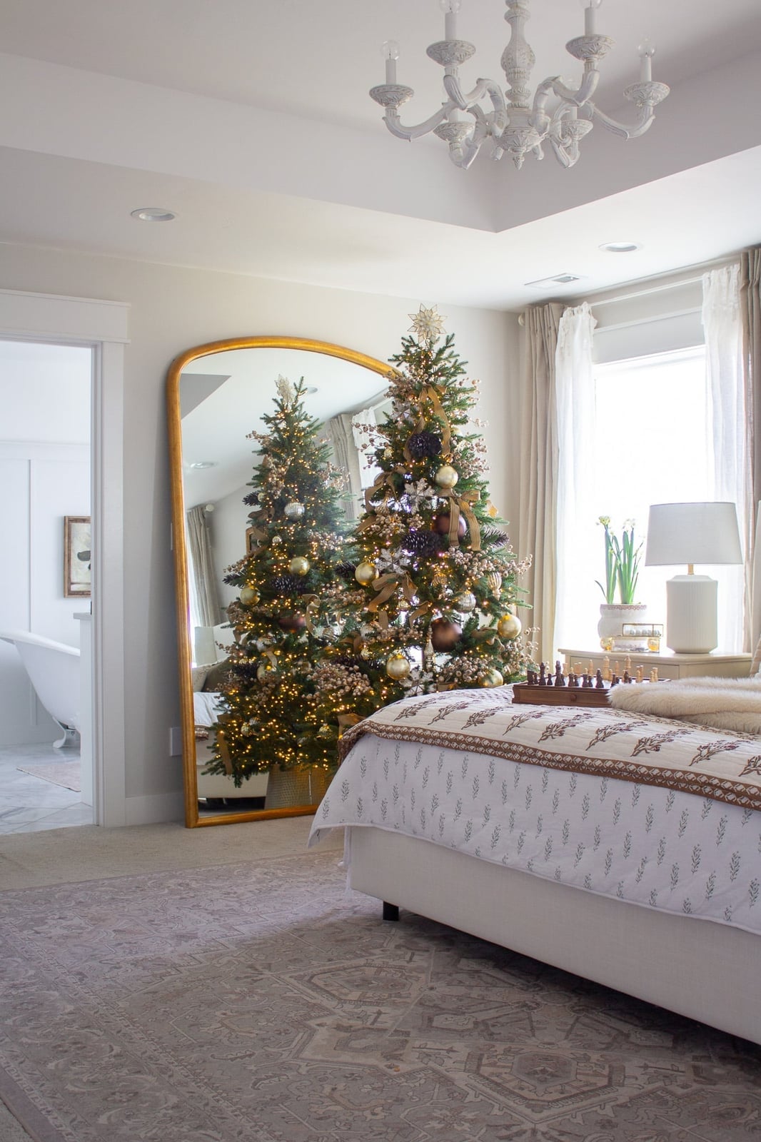 Neutral Farmhouse Bedroom with Ornate Mirror and Christmas Tree — cozy christmas bedroom 2026